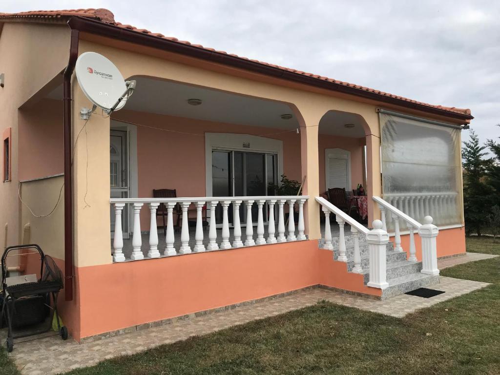 a house with a balcony and a satellite at Вила Маламос in Paralía Avdhíron