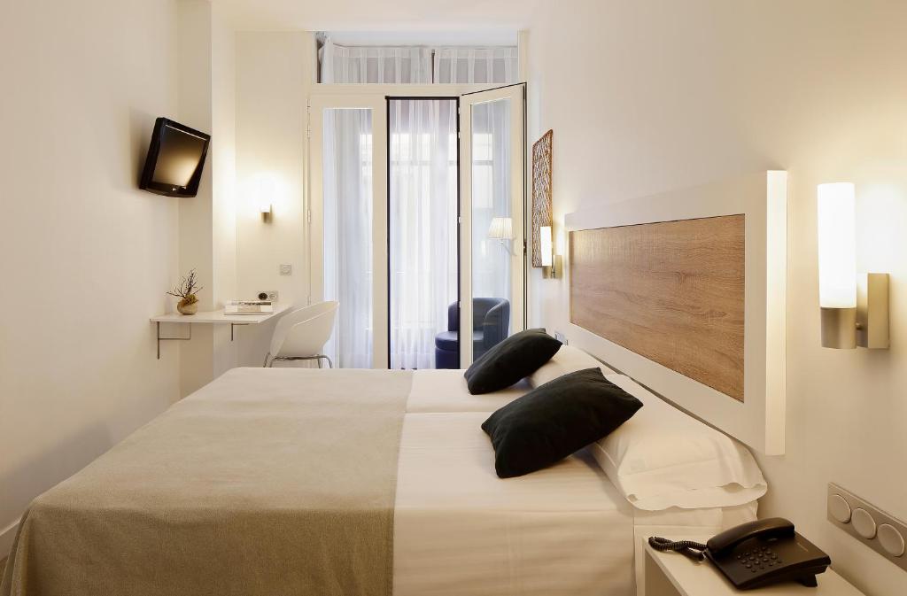 a bedroom with a large bed in a room at Hotel Santa Rosa, Blue Hoteles in Gijón