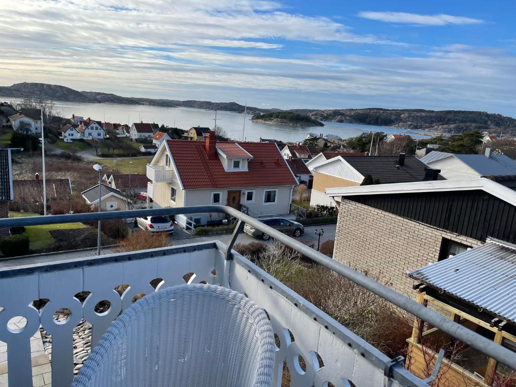 een witte stoel op het balkon van een huis bij Tallgatan Fjällbacka in Fjällbacka