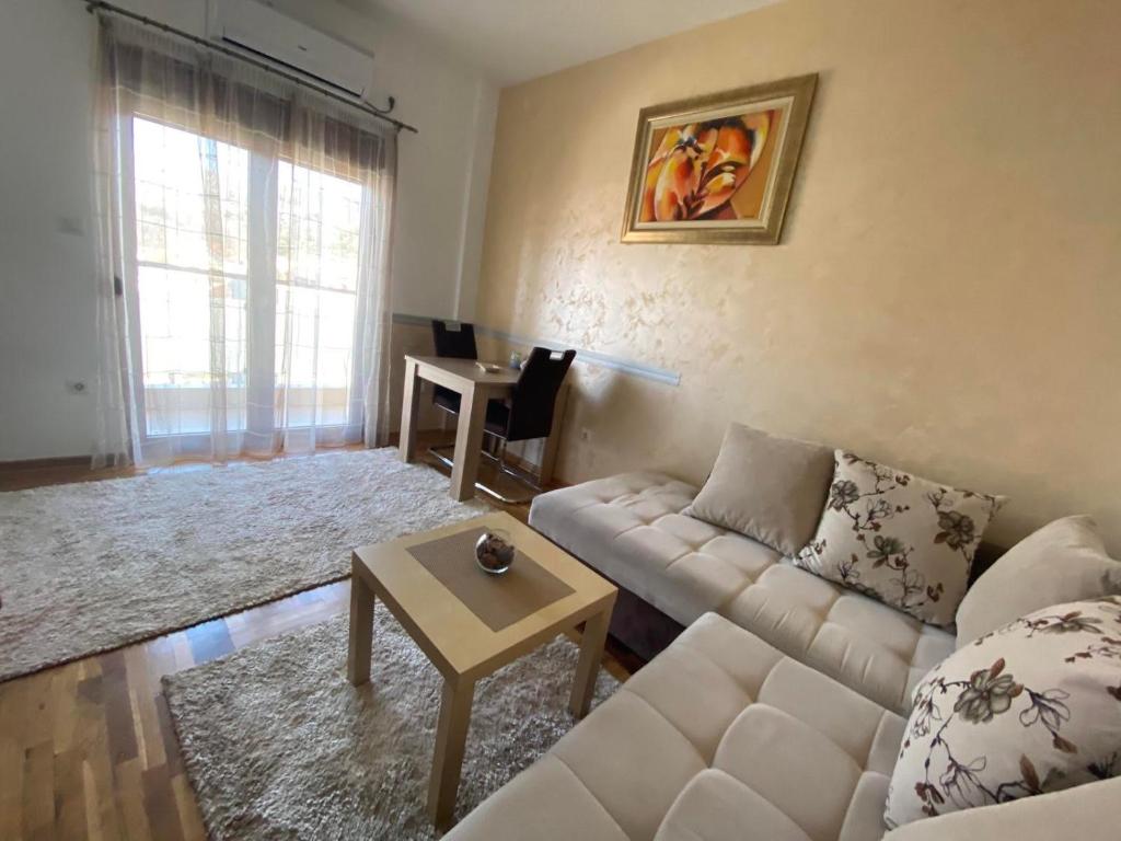 a living room with a couch and a table at Apartman Bojanic in Podgorica