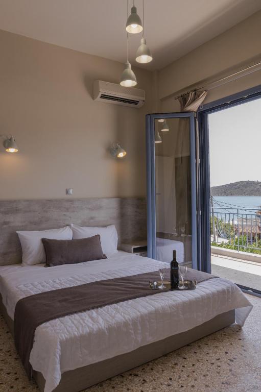a bedroom with a large bed and a large window at Vivari Acta in Vivari