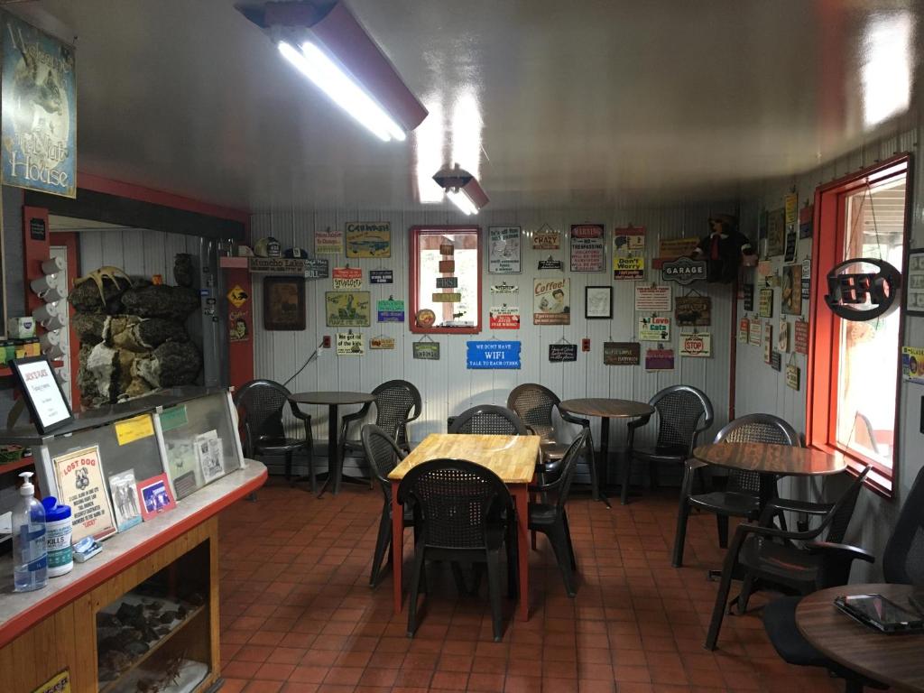 a dining room with tables and chairs in a restaurant at Double G Service in Muncho Lake