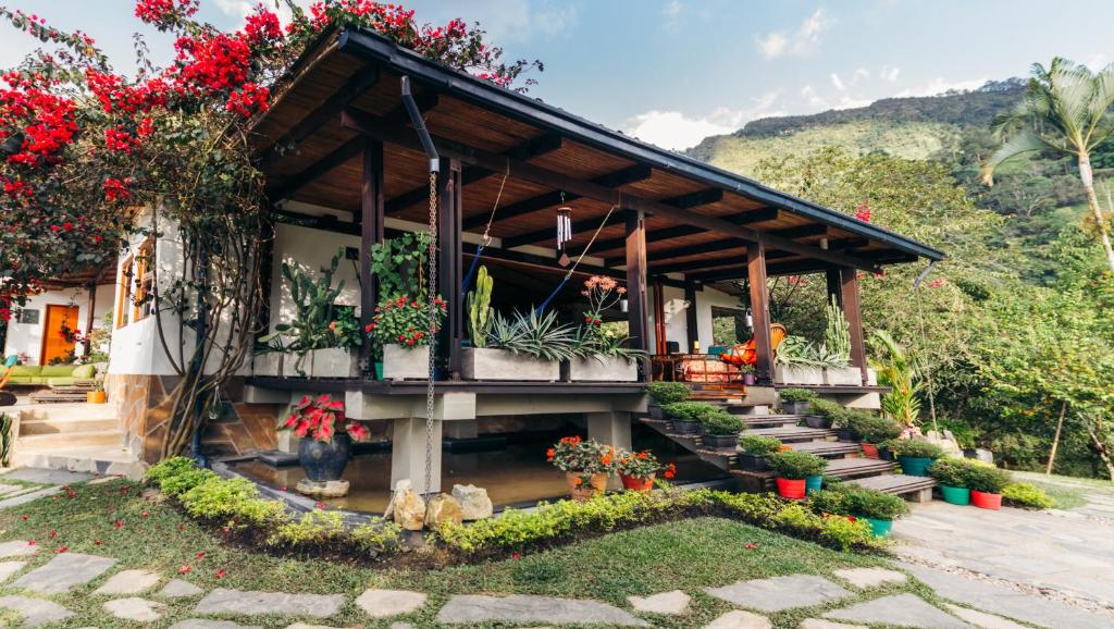 a house with a bunch of flowers on it at Finca Quebradahonda in La Vega