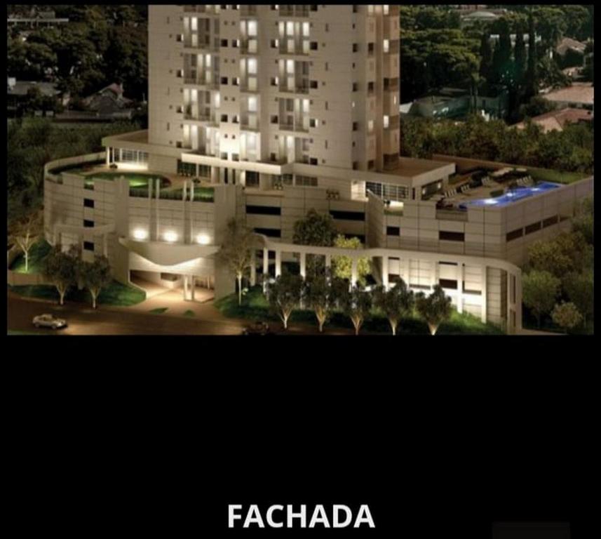 a large white building with lights in front of it at Duplex Impression Morumbi in São Paulo