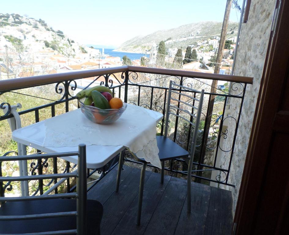a bowl of fruit on a table on a balcony at GRANDMA'S HOUSE in Symi