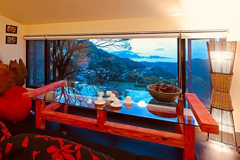 a room with a glass table and a large window at Windsor's Breeze in Jiufen