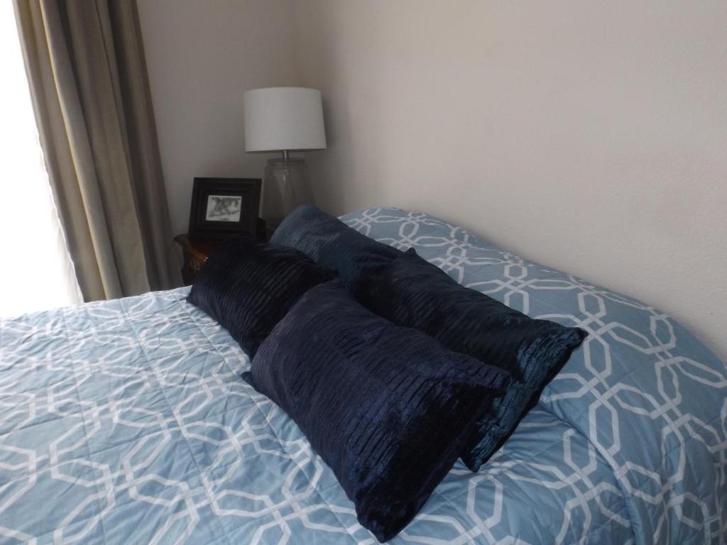 a bed with two pillows on it in a bedroom at Departamento UNIVERSITARIO en fraccionamiento privado in Chihuahua