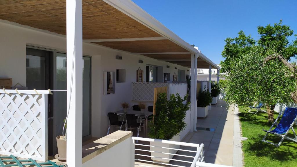 um alpendre de uma casa com uma cerca branca em lu Ientu house in Otranto, Baia dei Turchi area em Alimini