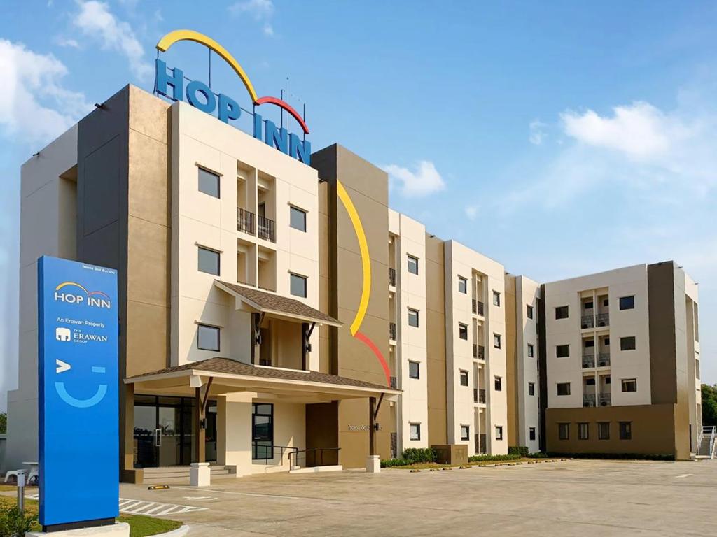 a hotel building with a sign in front of it at Hop Inn Nan in Nan