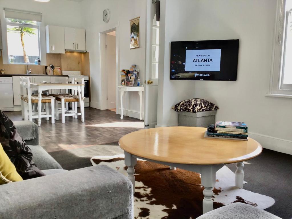 a living room with a table and a kitchen at Horlock House in New Town