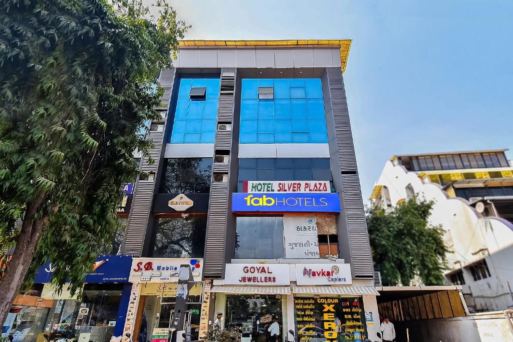 a building with a sign on the front of it at FabExpress Silver Plaza in Ahmedabad