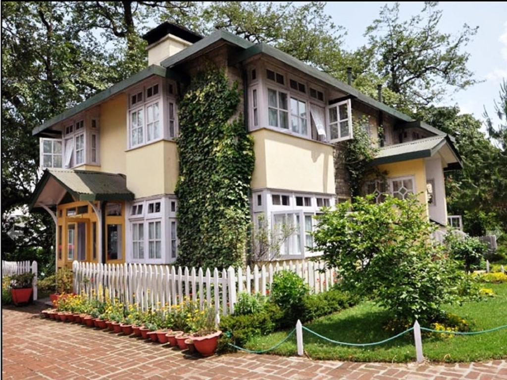 a house with ivy on the side of it at Windamere Hotel - A Colonial Heritage Since 1841 in Darjeeling