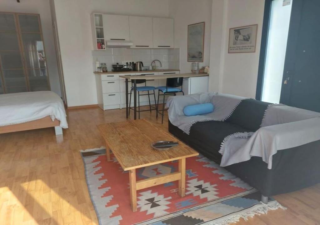 ein Wohnzimmer mit einem Sofa und einem Tisch in der Unterkunft Studio Room Ensuite by the Beach, Entire Independent Unit in Limassol