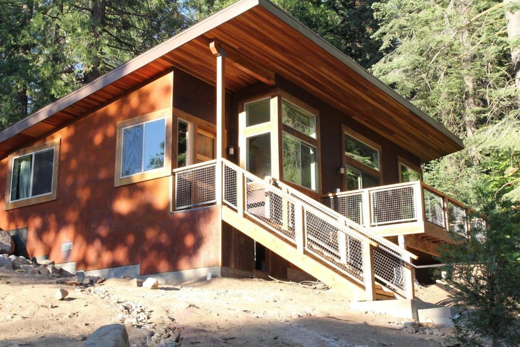 a house with a large deck on the side of it at Alpenglow 2 in Yosemite West