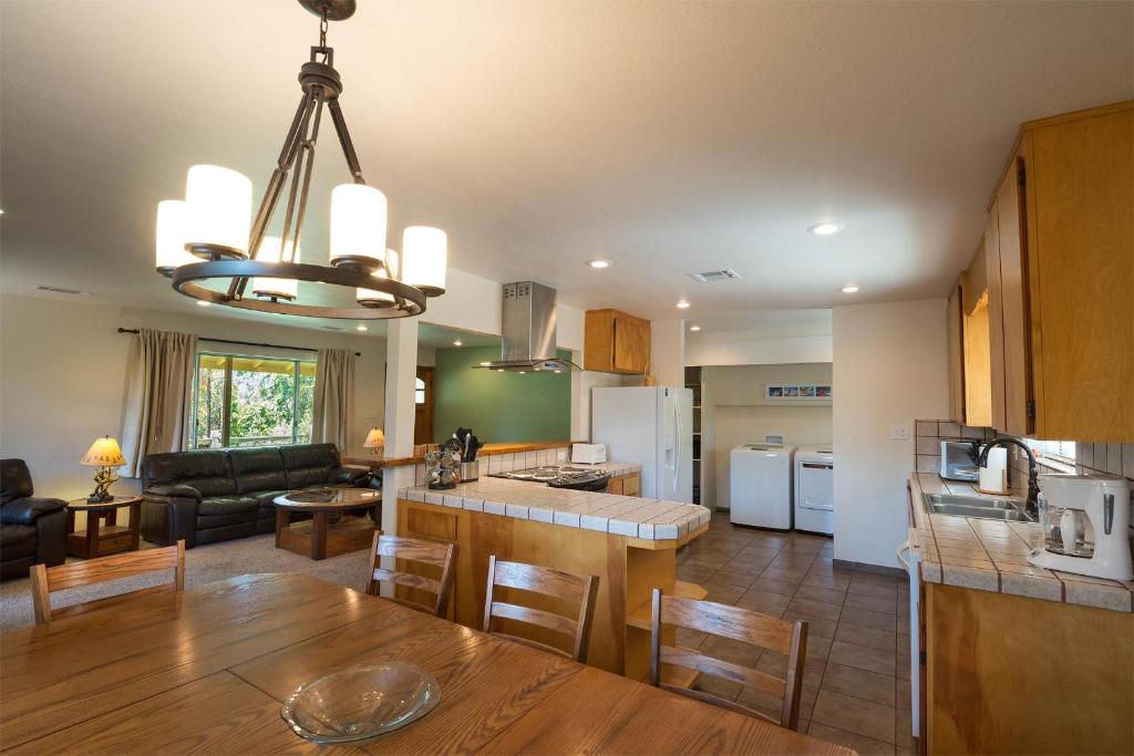 a kitchen and living room with a table and chairs at Blue Bird Ranch in Oakhurst