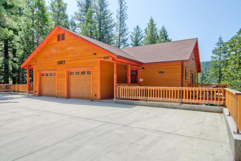 a large wooden barn with two garage doors at Sequoias West in Yosemite West