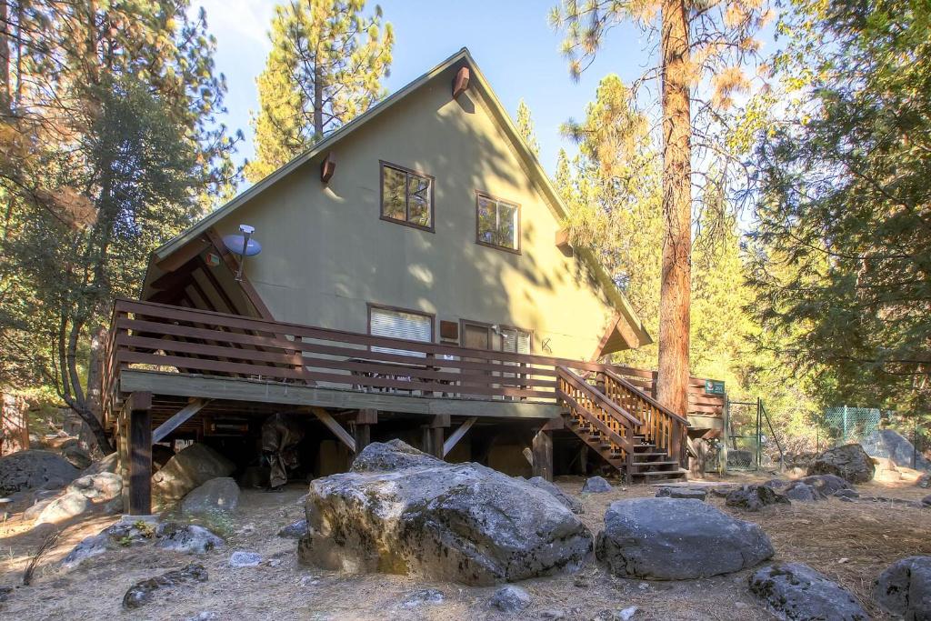 a cabin in the woods with rocks and trees at Yosemite's Creekside Birdhouse in Wawona