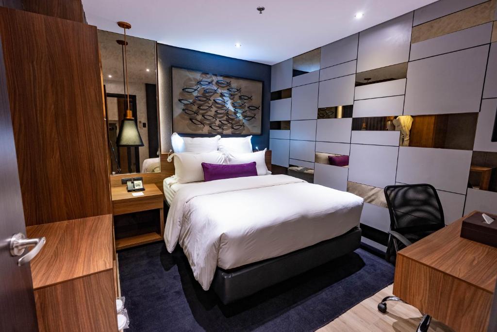 Postel nebo postele na pokoji v ubytování Coro Hotel