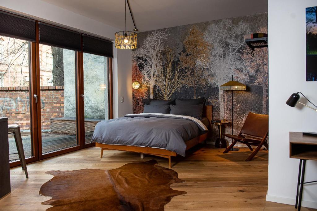 a bedroom with a bed and a large window at Urbn Dreams II in Berlin