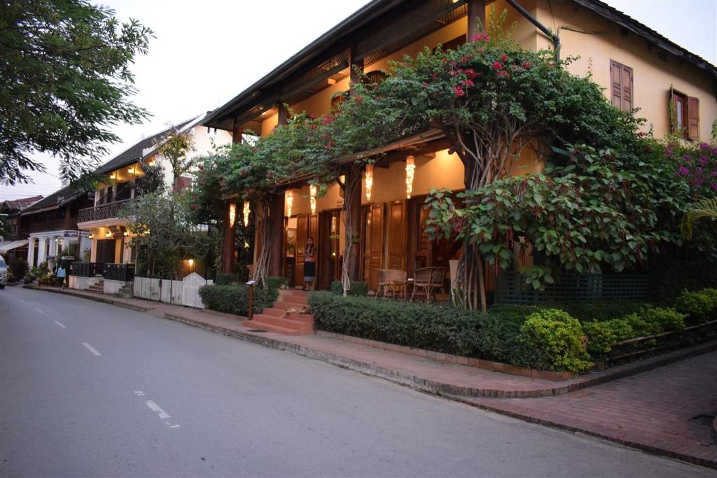 um edifício com plantas ao lado de uma rua em Sala Prabang Hotel em Luang Prabang