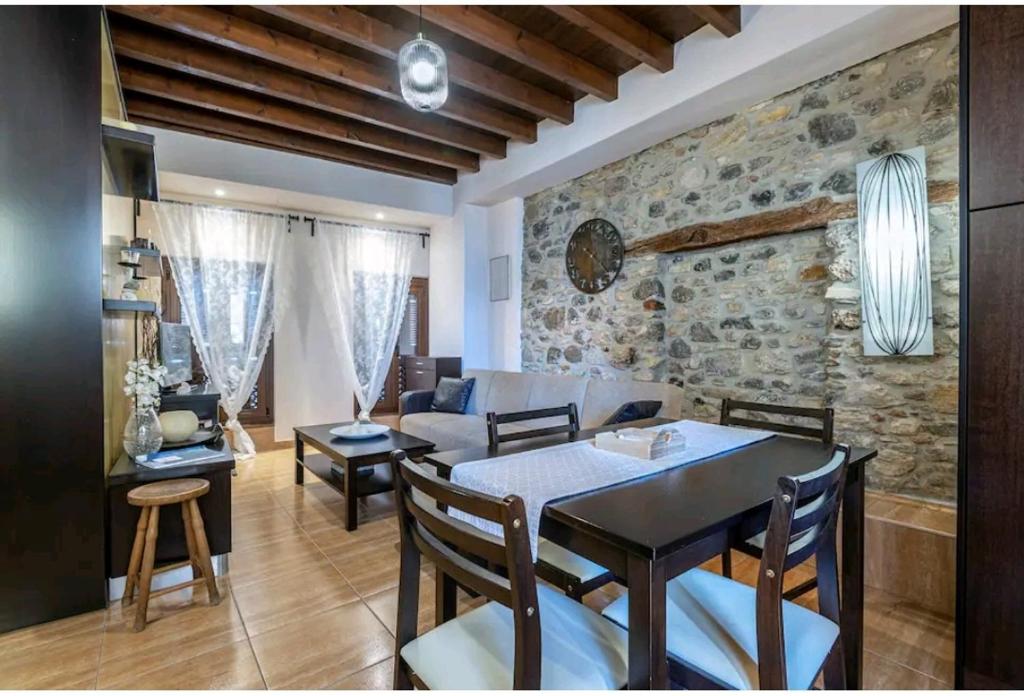 a dining room and living room with a table and chairs at Unique home in Kos Town