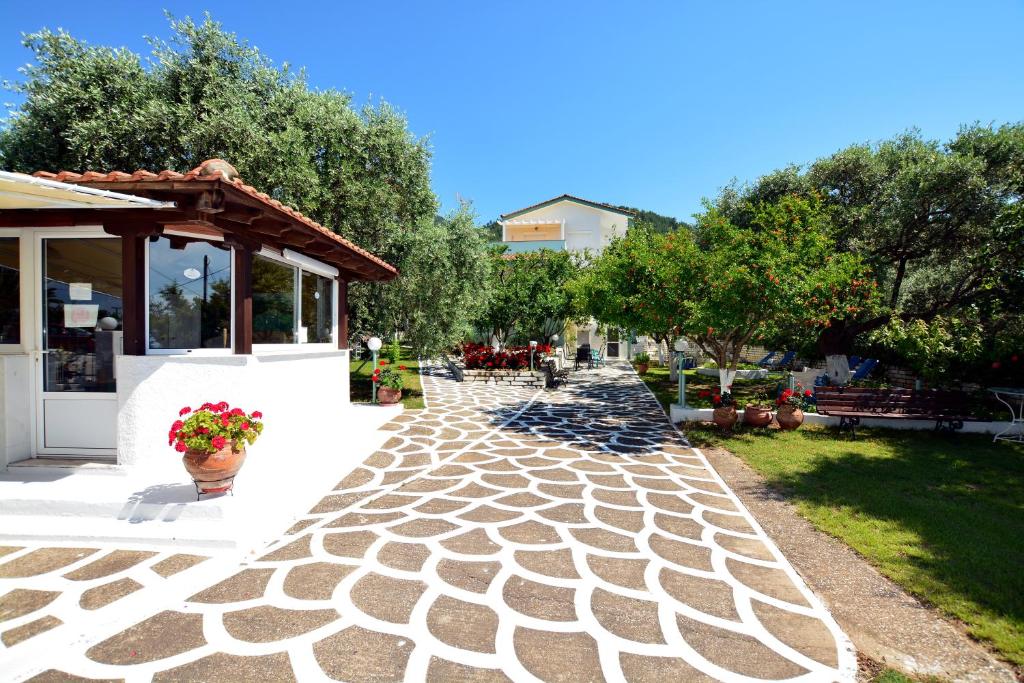 a cobblestone walkway next to a building with a pavilion at Villa Emilia in Pachis