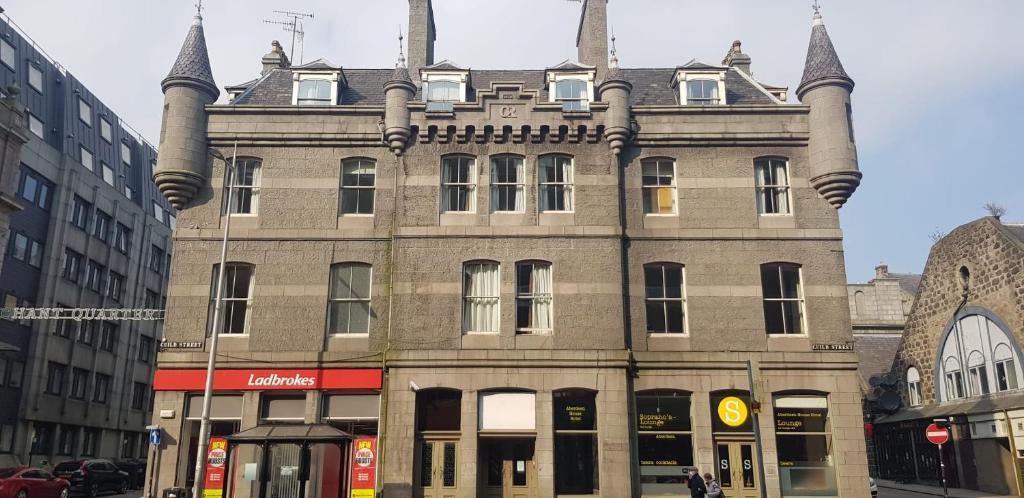 an old building with turrets on a city street at Aberdeen House in Aberdeen