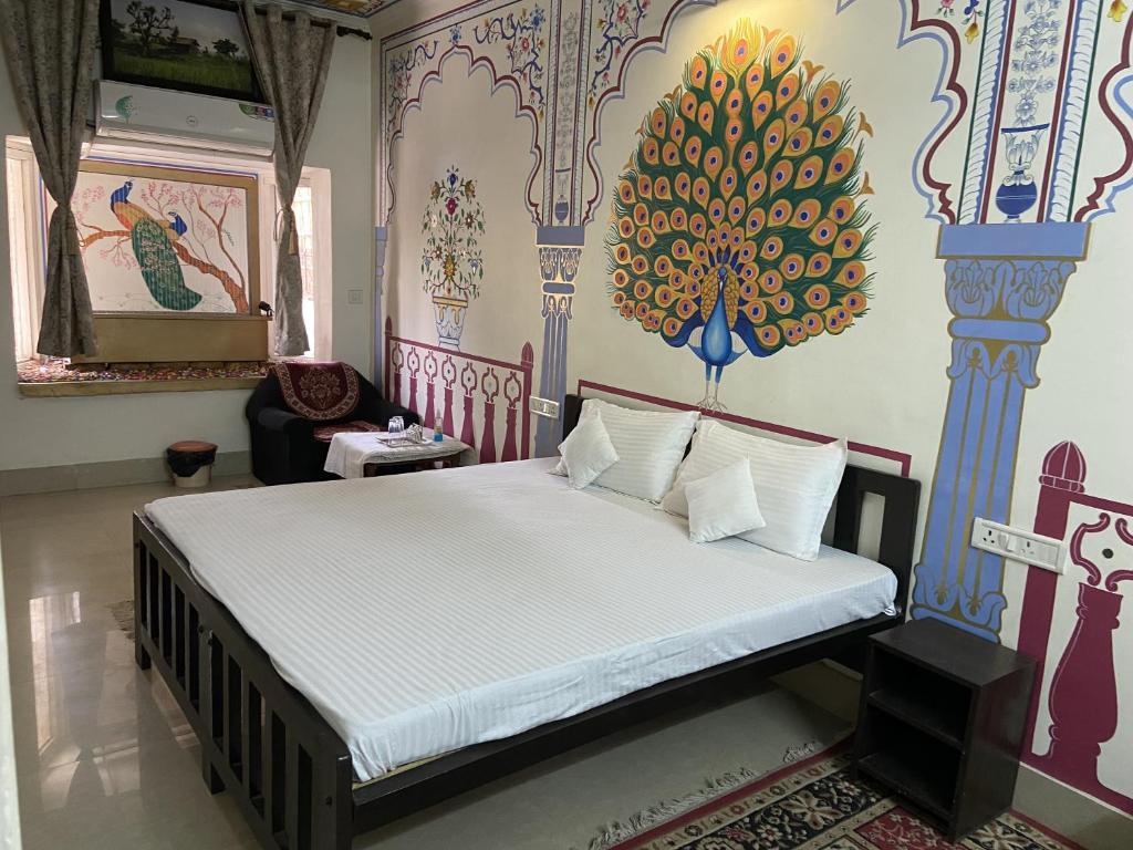 A bed or beds in a room at Golden Peacock Heritage Home Stay