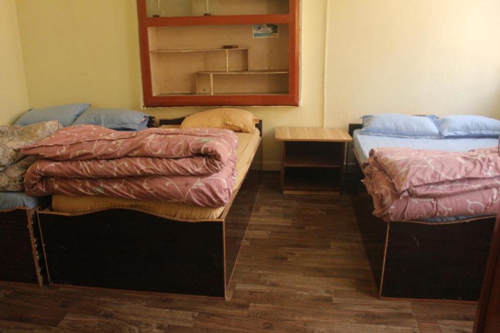 Postel nebo postele na pokoji v ubytování Universal Hotel & Lodge - Gorkha