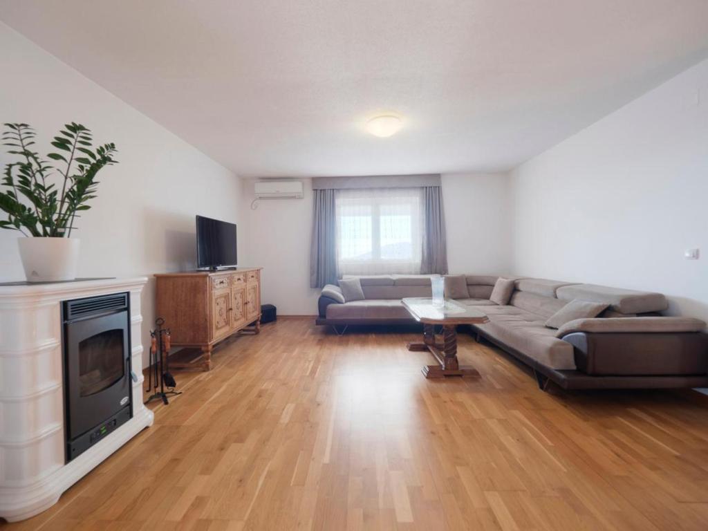 a living room with a couch and a fireplace at Apartments Branko in Budva