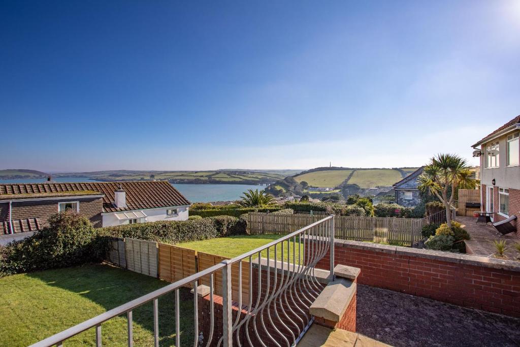 a balcony of a house with a view of the water at Beau Vista Ground Floor Apartment in Padstow