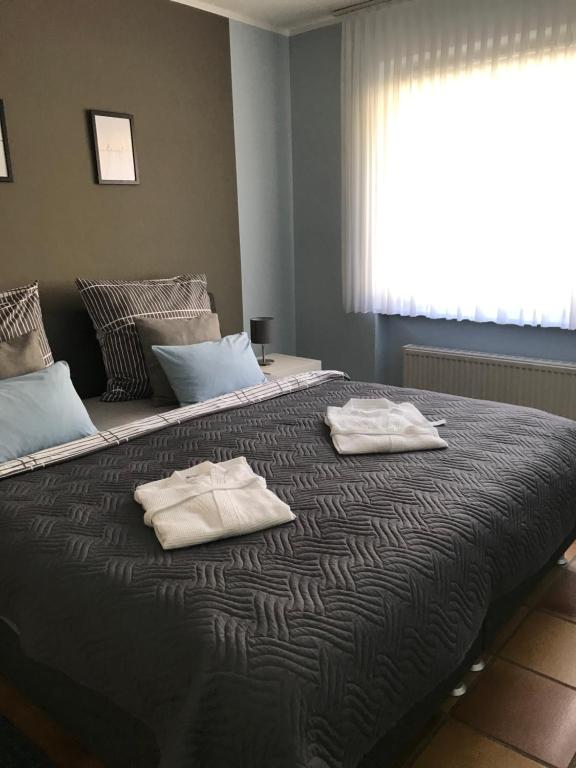 a bedroom with a large bed with towels on it at Ferienwohnung Frevel in Pommern