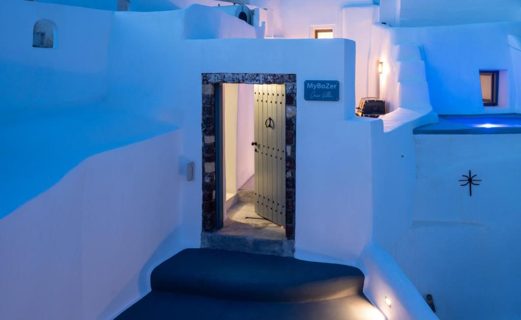 a hallway with a door in a room with blue lights at MyBozer Cave Villa in Karterados