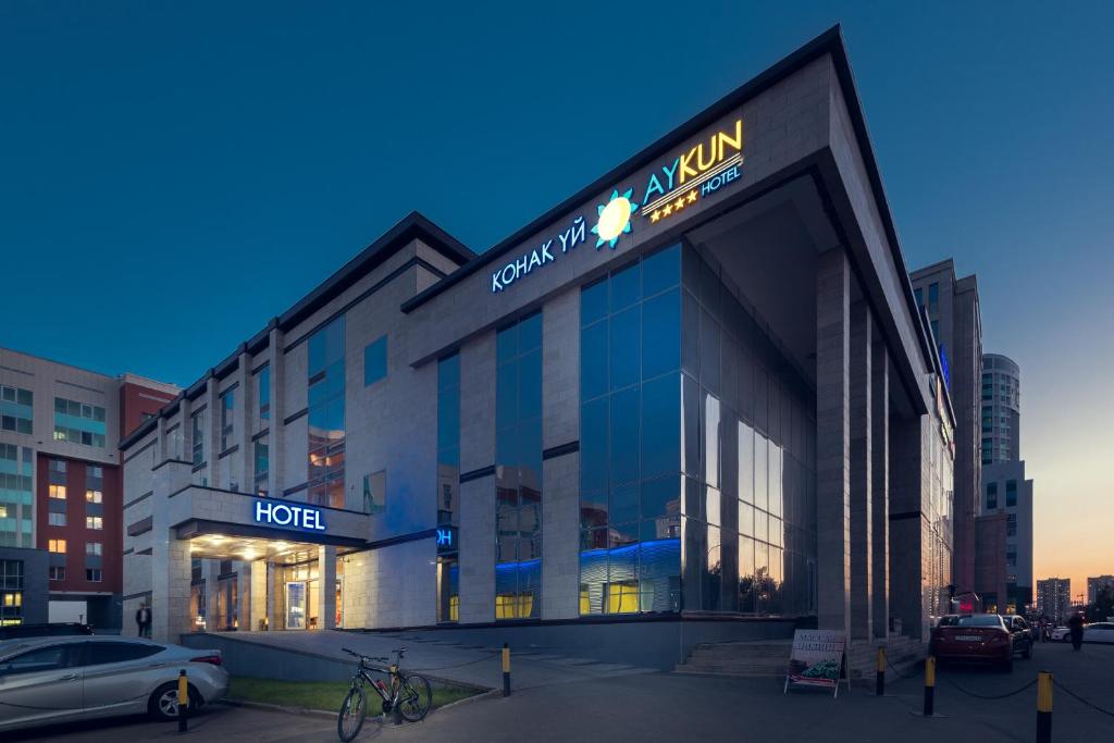 a hotel building with a sign on the front of it at AYKUN Hotel by AG Hotels Group in Astana