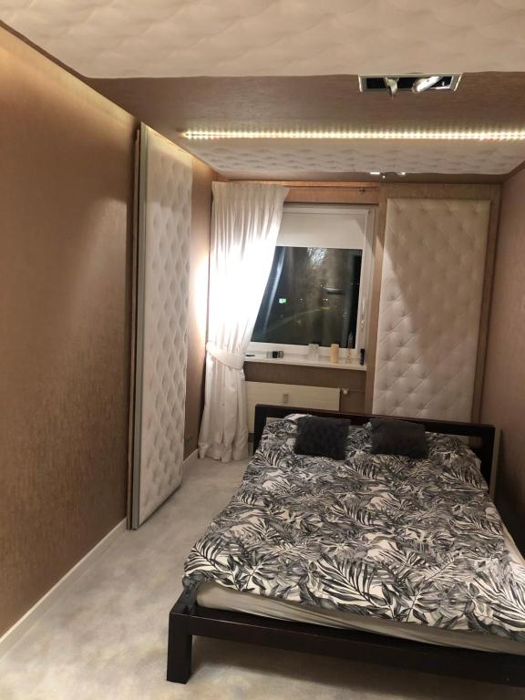 מיטה או מיטות בחדר ב-BlaBlaFlat Szczecin Santocka