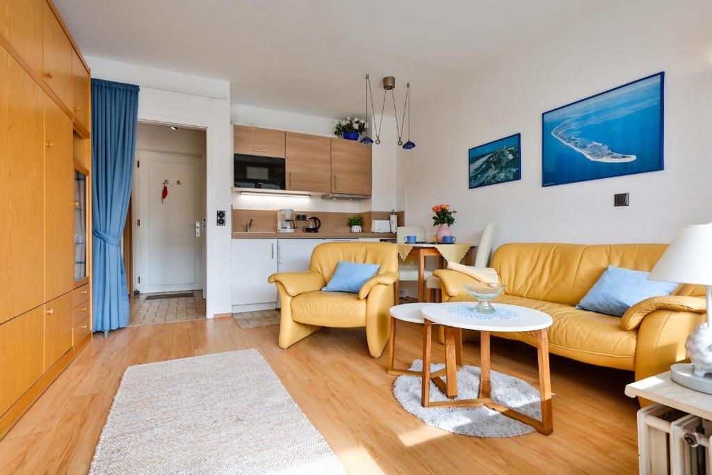 a living room with a couch and a table at Kniepsand in Hörnum