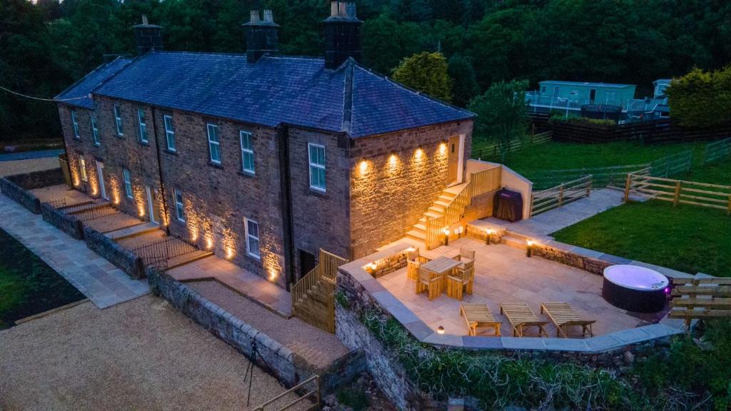 an aerial view of a brick building with lights on it at Foundry Farm Cottage in Hexham