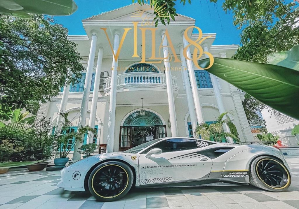 a white car parked in front of a building at Villa 86 in Ho Chi Minh City