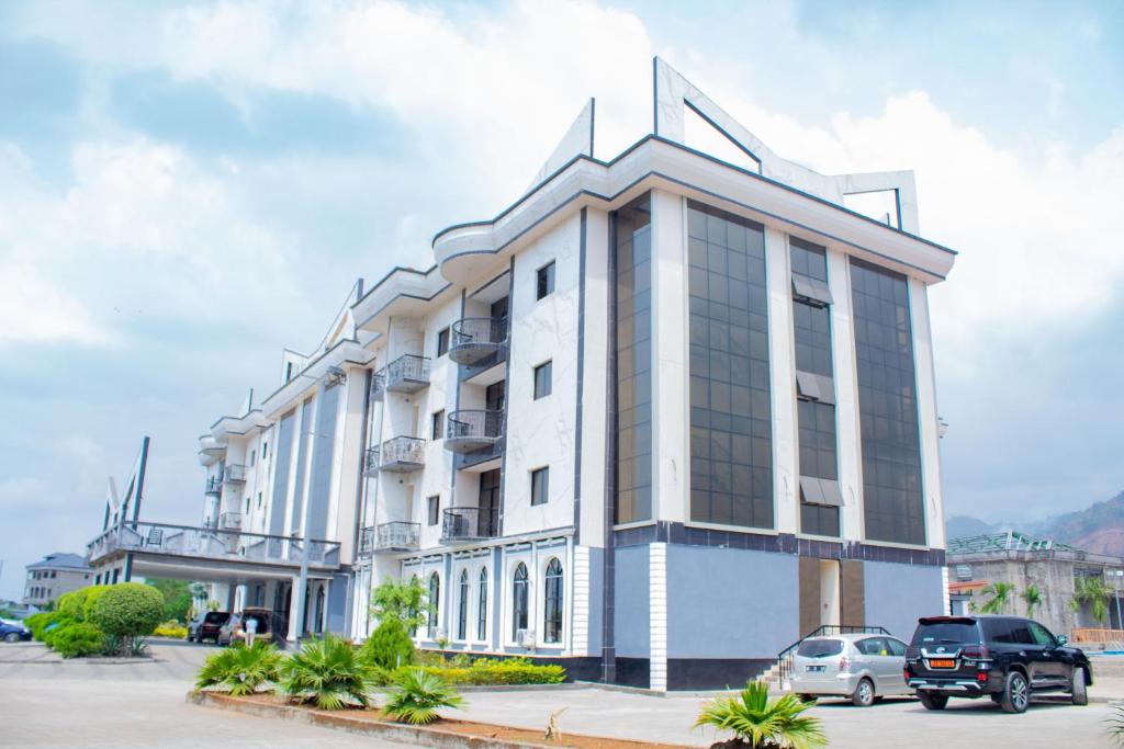 a building with cars parked in front of it at Marcsons Hotels and Resorts in Limbe