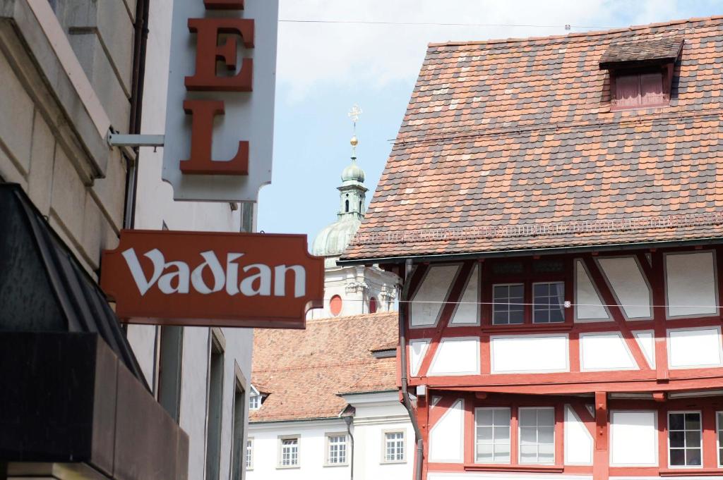 ein Gebäude mit einem gefliesten Dach auf einer Stadtstraße in der Unterkunft Hotel Vadian Garni in St. Gallen