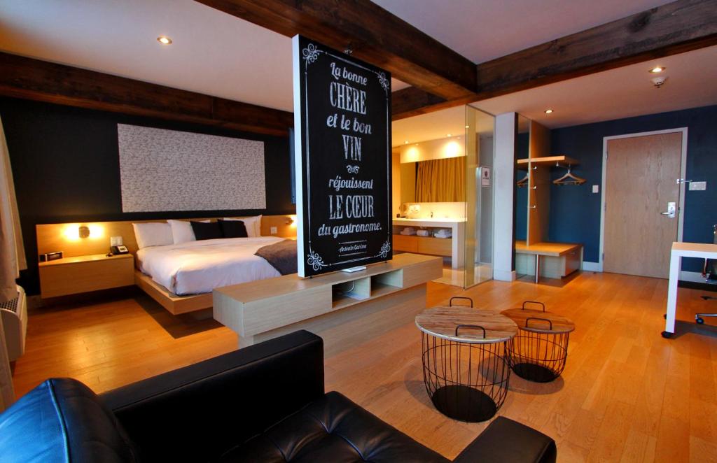 a hotel room with a bed and a large sign at La cache à Maxime in Scott
