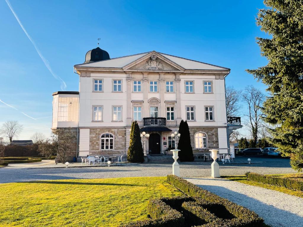 a large white building with a dome on top at Pałac Brunów - Wellness &amp; SPA in Lwówek Śląski