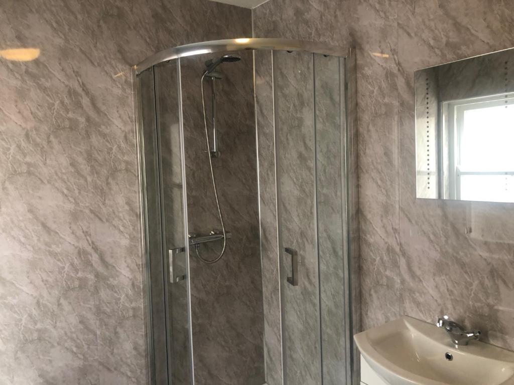 a bathroom with a shower and a sink at Wayfarer Inn in Instow
