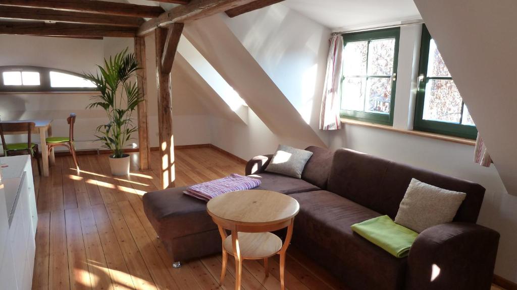 a living room with a couch and a table at Ferienwohnung am Erfurter Dom in Erfurt