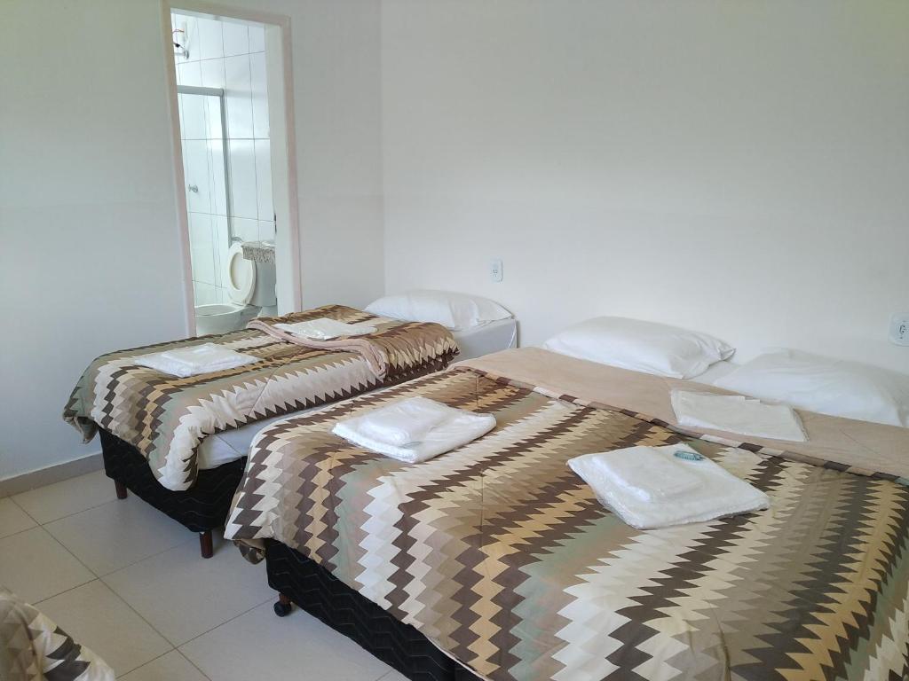 two beds sitting next to each other in a room at POUSADA VILA DO BIRIBIRI in Diamantina