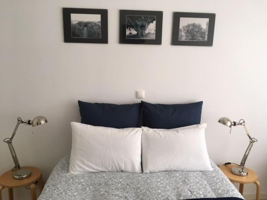 a bedroom with a bed with two lamps on two tables at Charming Suite Private Wc & Balcony in Lisbon