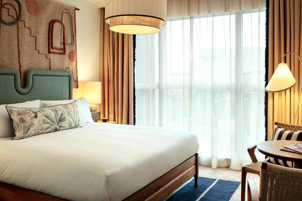 a hotel room with a bed and a window at The Hoxton, Poblenou in Barcelona