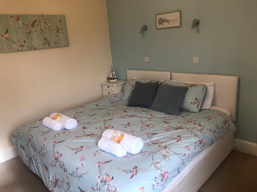 a bedroom with a bed with towels on it at Wayfarer Inn in Instow