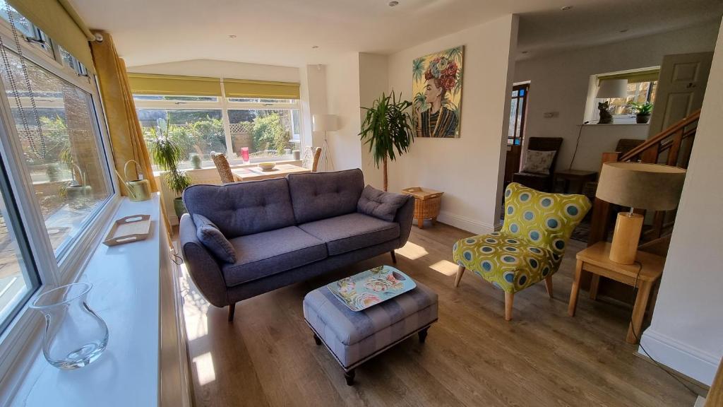 a living room with a couch and a chair at Garden Cottage - Ashover Village near Matlock in Chesterfield