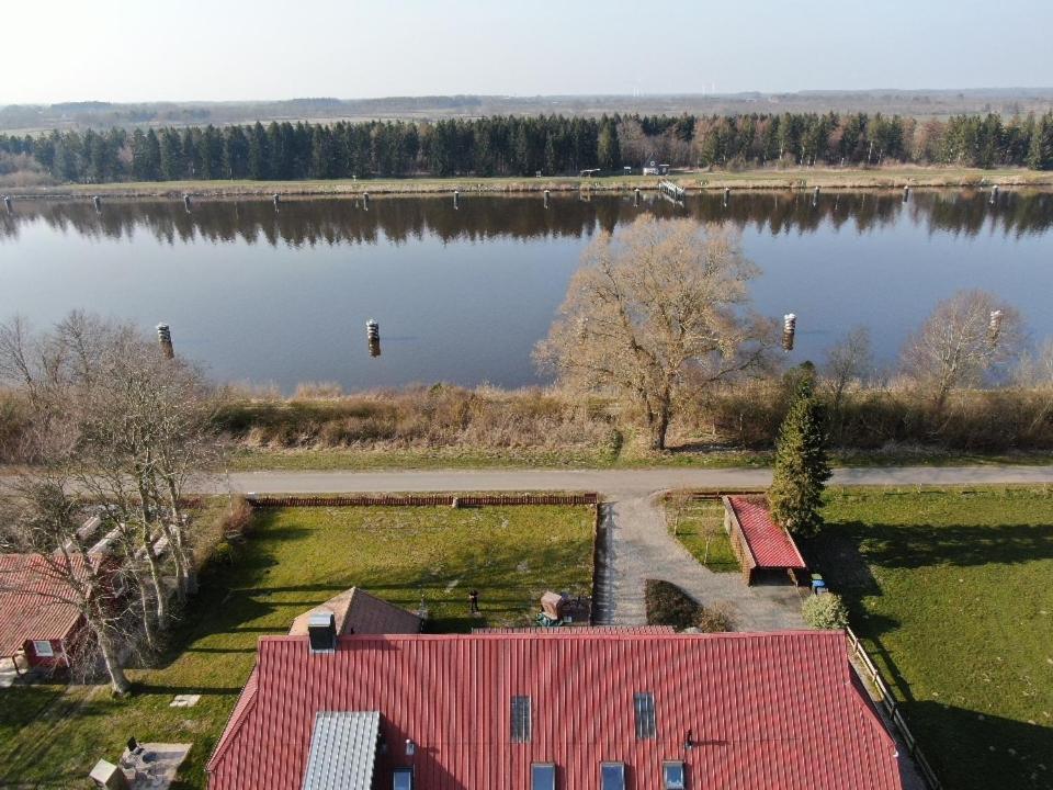 una vista aérea de una casa junto a un lago en Ruhige Ferienwohnung direkt am Nord-Ostsee-Kanal en Breiholz